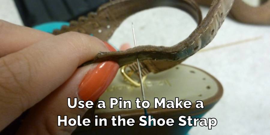 Use a Pin to Make a Hole in the Shoe Strap